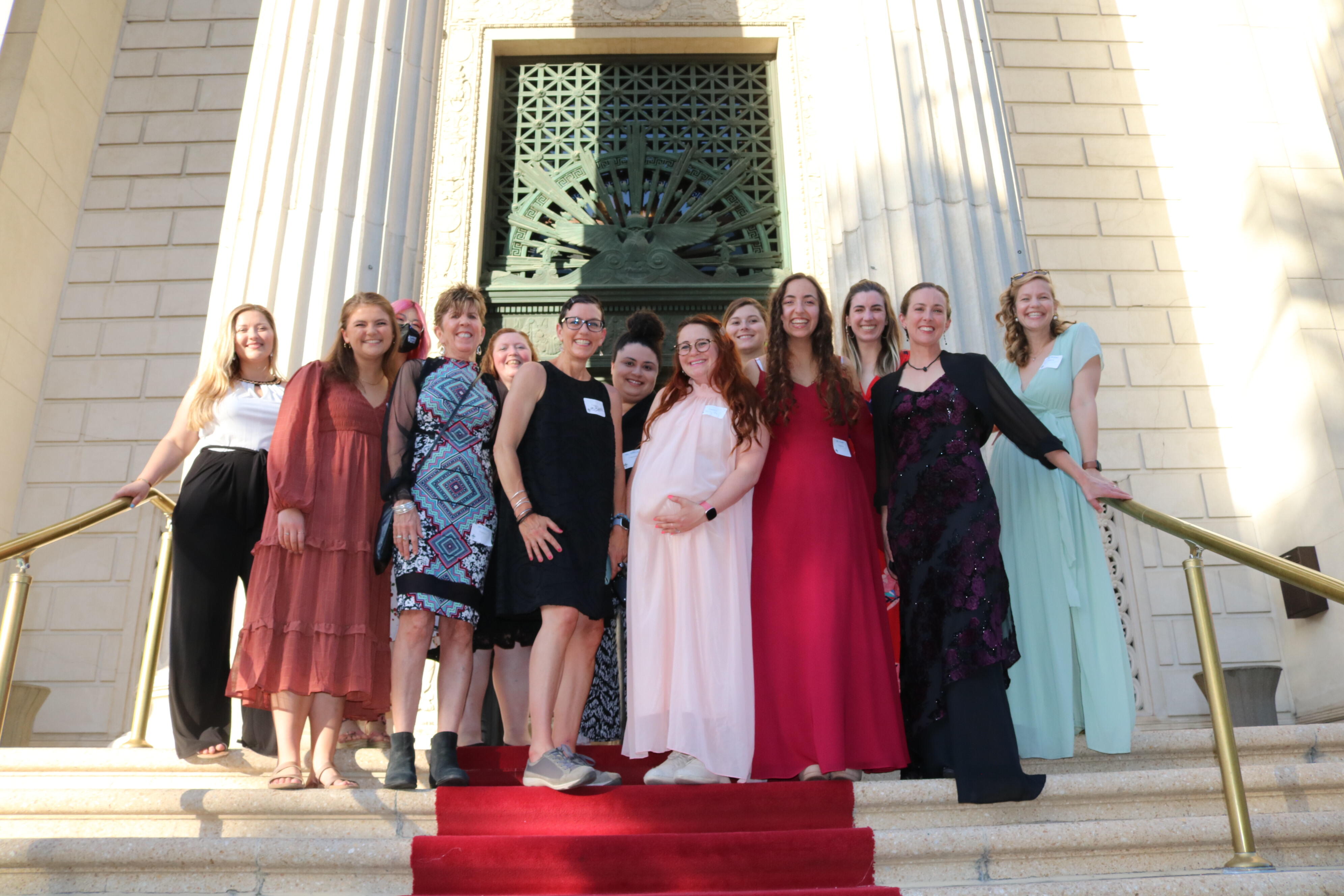 ND faculty and staff chaperones on the red carpeted steps at the Corinthian Event Center